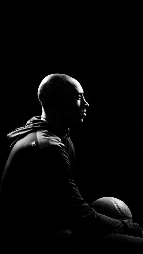 Enigmatic Elegance: Black Background, Kobe Bryant Graces with a Basketball Wallpaper