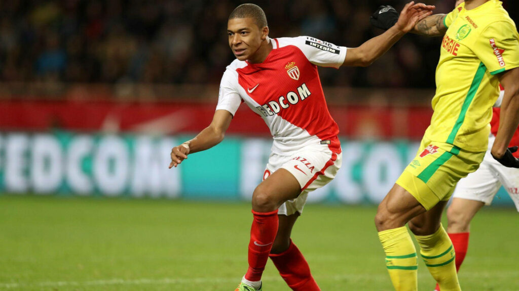 Kylian Mbappe in Action: Unique Pose Football Wallpaper Background