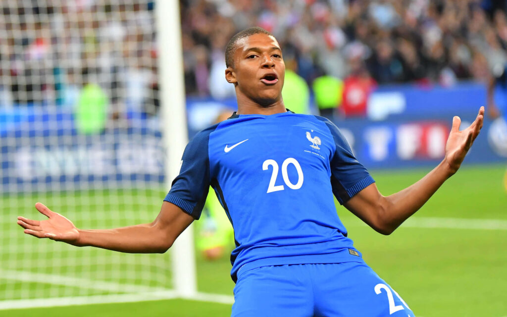 Kylian Mbappe Dynamic Celebration Wallpaper - French Football Star