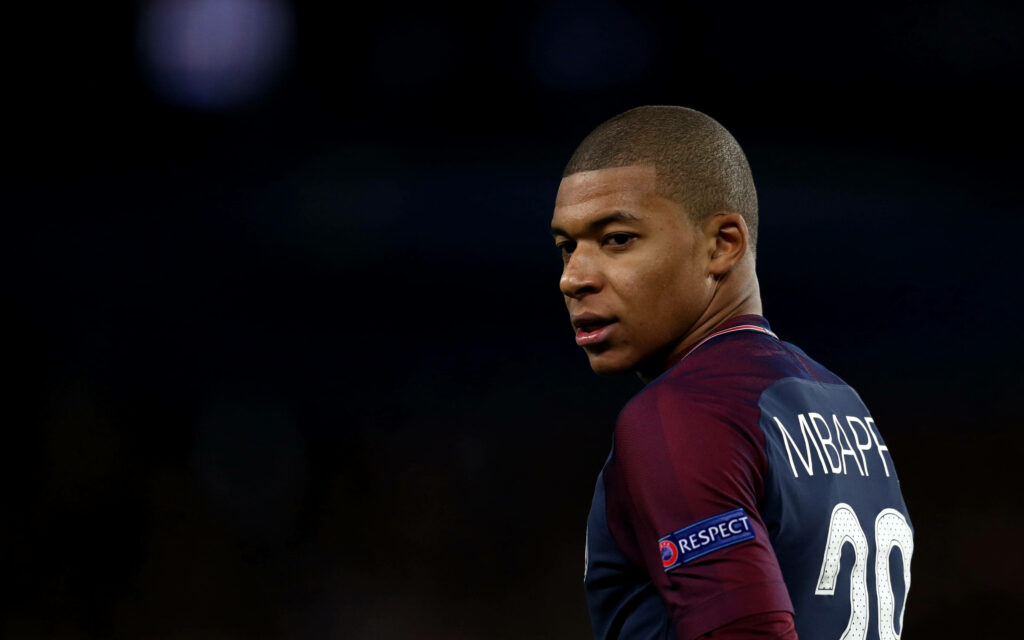 Dynamic Kylian Mbappe Side-View Portrait Wallpaper Background