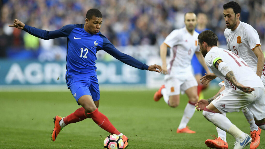 Kylian Mbappe in Action: Agility & Precision Football Wallpaper