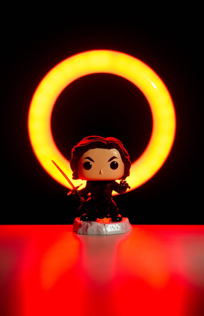 Funko Pop Kylo Ren with red lightsaber glowing orange ring light dark Star Wars wallpaper
