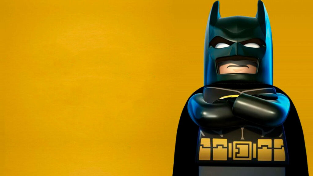 LEGO Batman in iconic suit posing confidently against vibrant yellow background 4k wallpaper