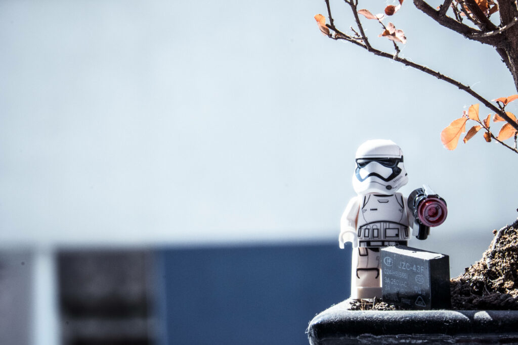 LEGO Star Wars Stormtrooper standing under vibrant orange tree with muted background wallpaper