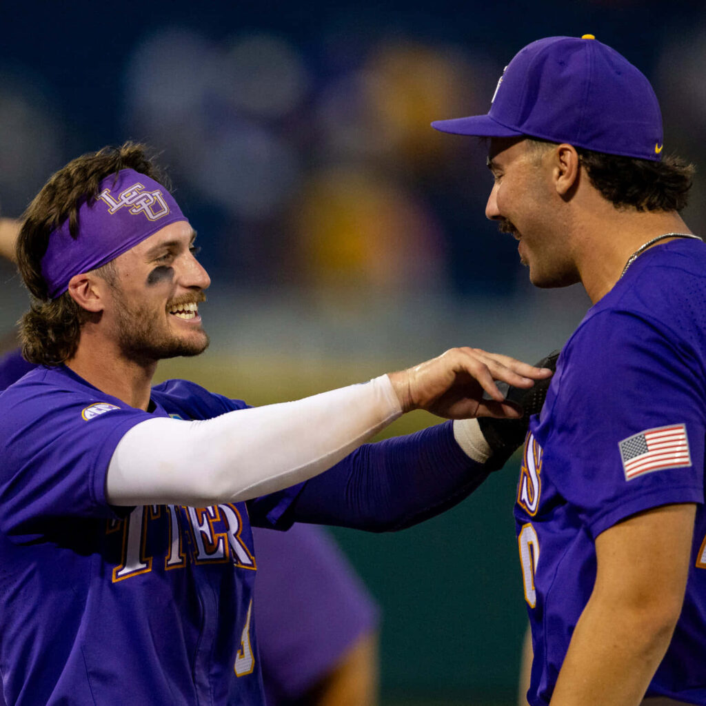 LSU Baseball Dylan Crews celebrating with teammate in purple gold uniforms vibrant stadium background Wallpaper