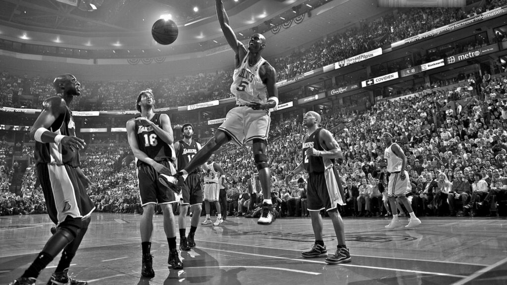 Black and white Lakers vs Celtics basketball action wallpaper with intense game and crowd energy