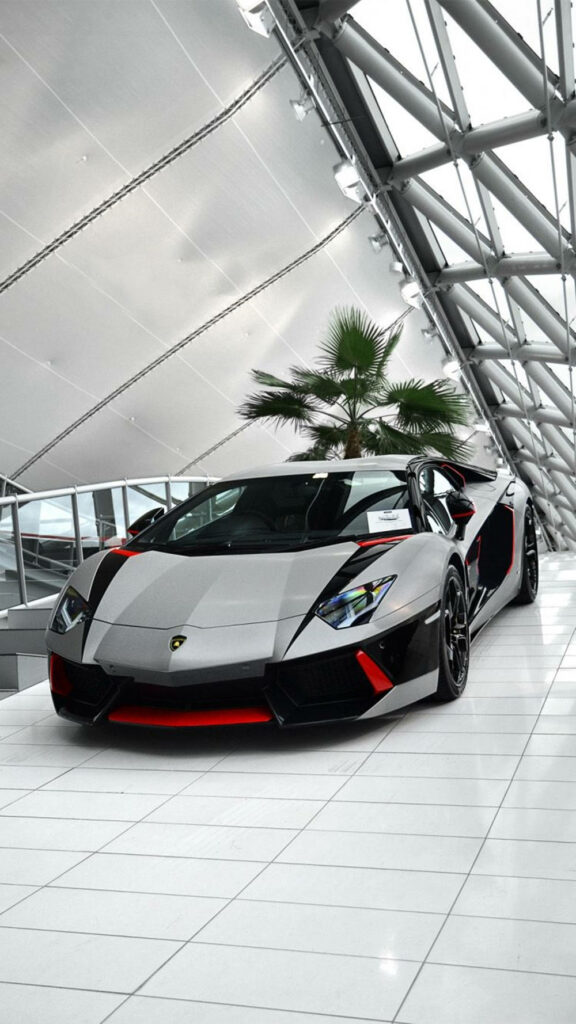 Sleek Lamborghini inside modern white building with natural light highlighting luxury design wallpaper