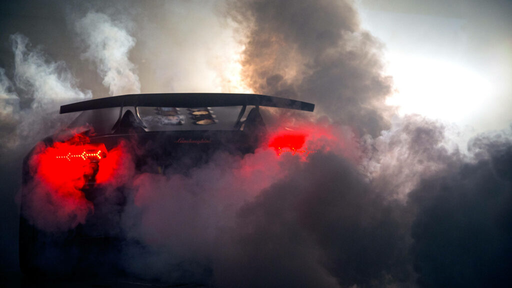 Lamborghini Sesto Elemento speeding with vivid tail lights through dense smoke dynamic sports car wallpaper