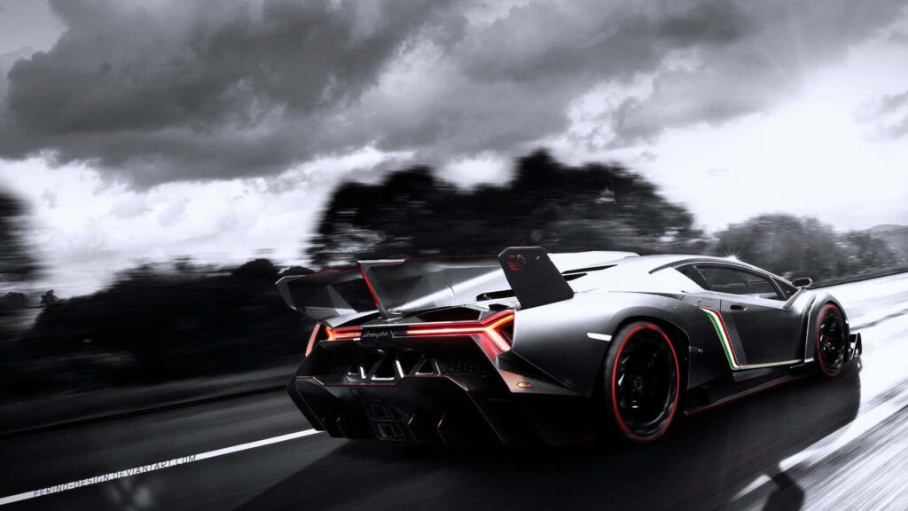 Lamborghini Veneno speeding on wet highway under stormy skies showcasing aerodynamic design Wallpaper
