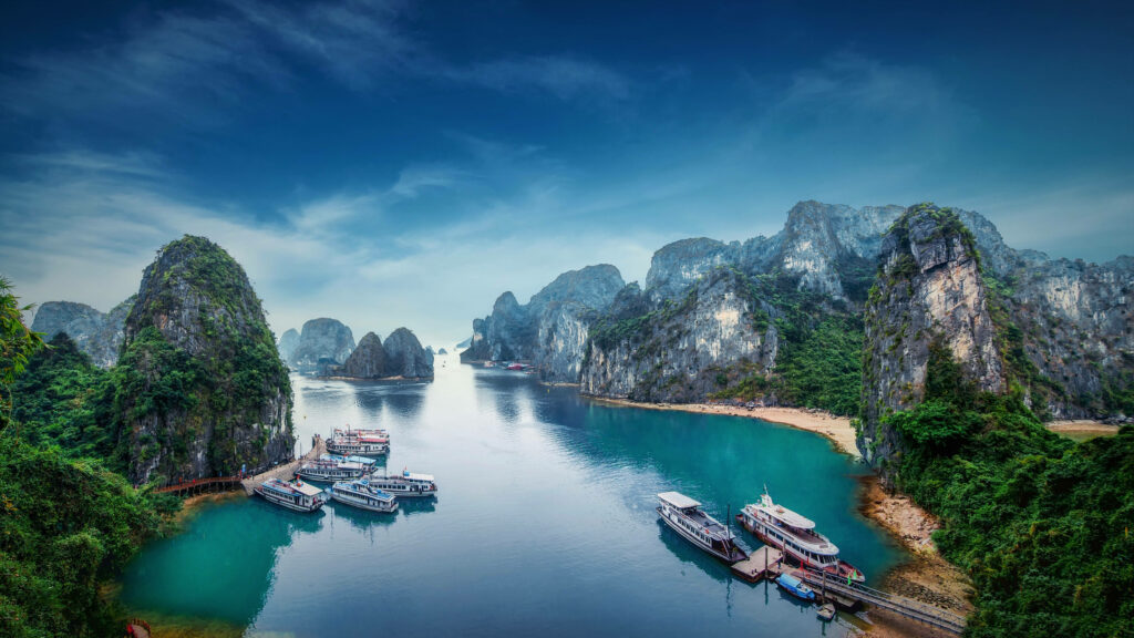 Lan Ha Bay Vietnam wallpaper with emerald waters boats limestone cliffs and lush greenery view