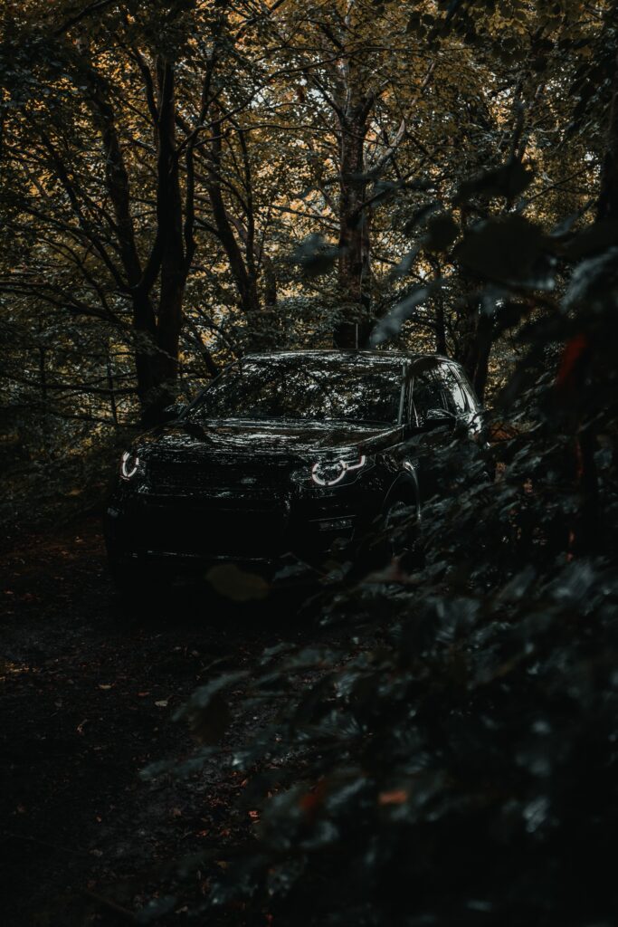 Land Rover Discovery 3 in Dense Forest - Rugged Adventure Wallpaper