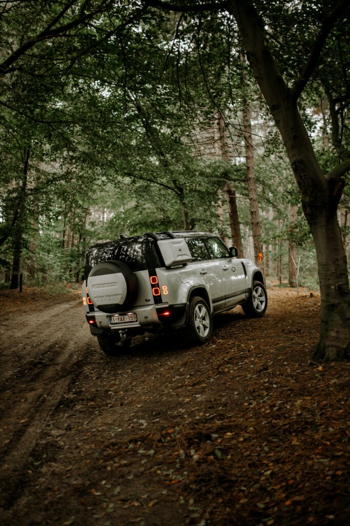 Land Rover SUV in Dense Forest: Adventure Wallpaper Background