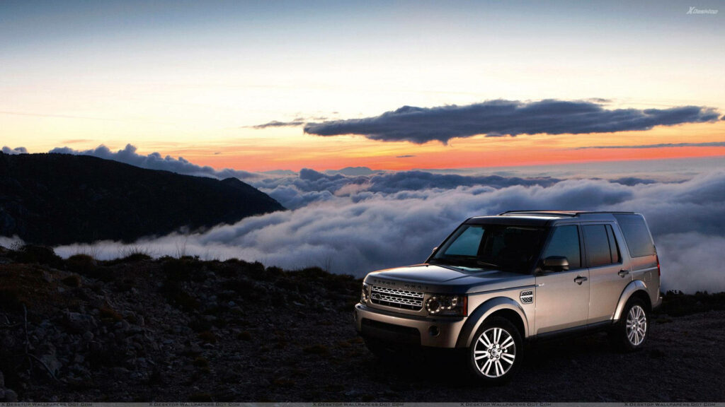 Land Rover Sunset Wallpaper: Rugged Elegance Meets Mountain Serenity