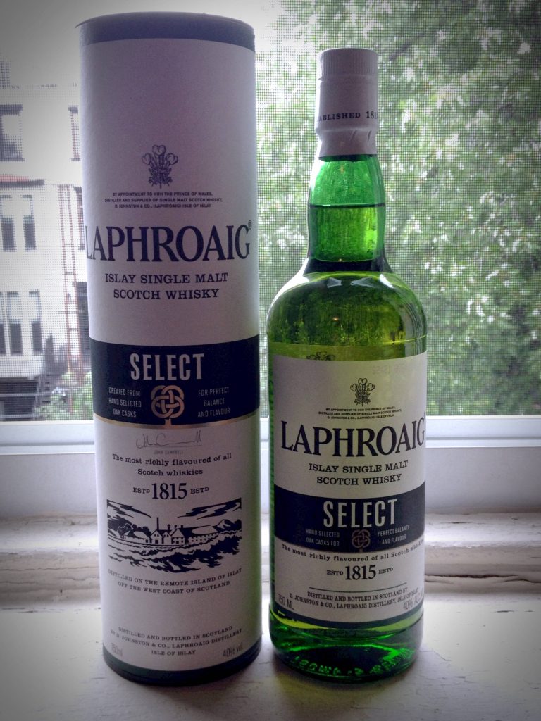Laphroaig Select Islay Scotch Whisky bottle and canister on bright windowsill in natural light Wallpaper