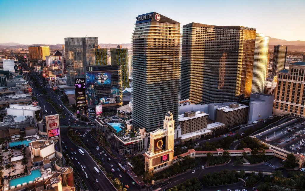 Aerial sunset view of Las Vegas Strip featuring Cosmopolitan Bellagio and Aria resorts vibrant energy Wallpaper
