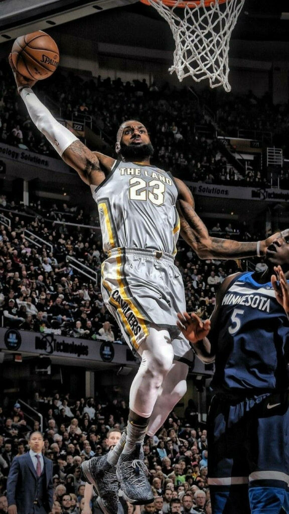 LeBron James Mid-Air Slam Dunk Wallpaper - Dynamic Athleticism