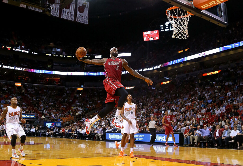 LeBron James Soars: Dynamic NBA Dunk Wallpaper Background