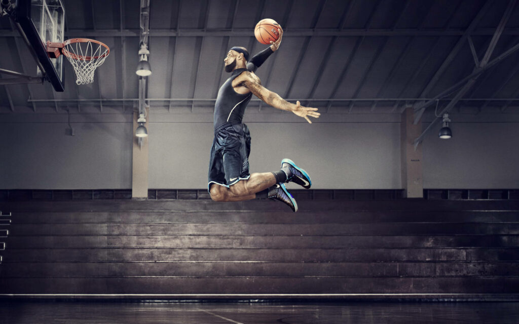 Dunking his way to greatness, witness Lebron James dominate the court in this stunning wallpaper!