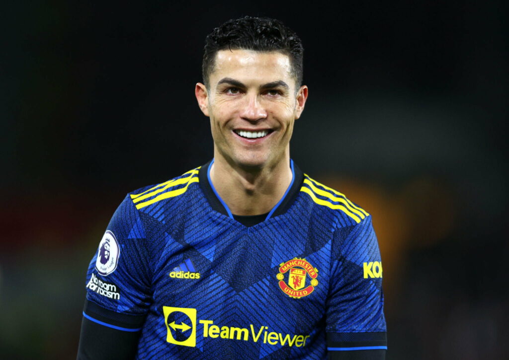 Ronaldo Reigns: Captivating Soccer Superstar Amidst a High-Definition Football Mural Wallpaper