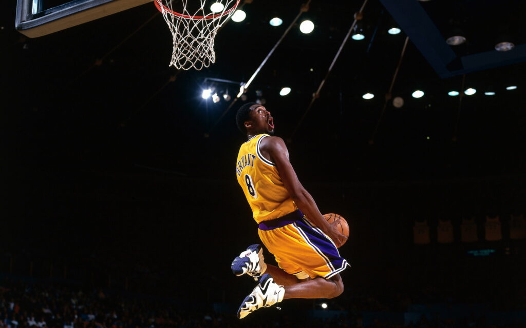 Dunking Legend: Kobe Bryant Soaring Above as a Lakers Icon in the NBA - QHD Wallpaper Image