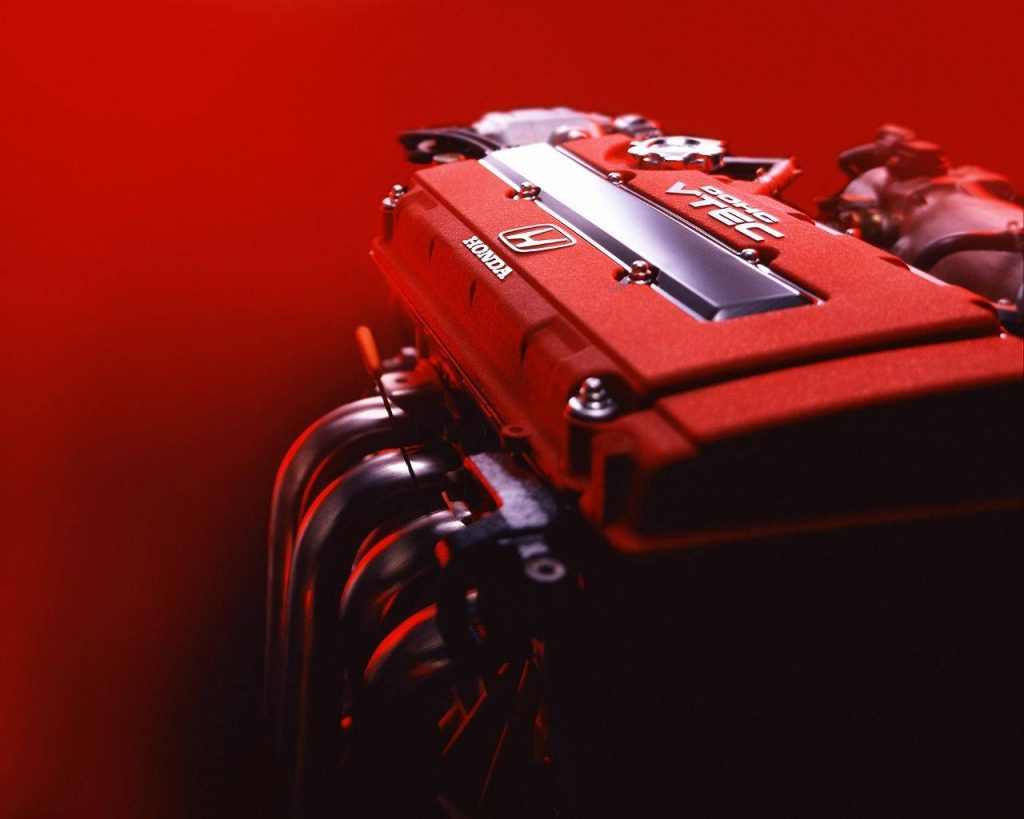 Close-up of legendary Honda DOHC VTEC red valve cover with cinematic lighting automotive wallpaper