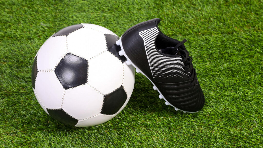 Black Shoe Crushes Soccer Ball on Dynamic 2560x1440 Soccer Background Wallpaper