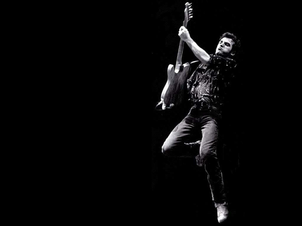 Rock Legend Bruce Springsteen Electrifies the Stage in an Iconic Guitar Solo Wallpaper
