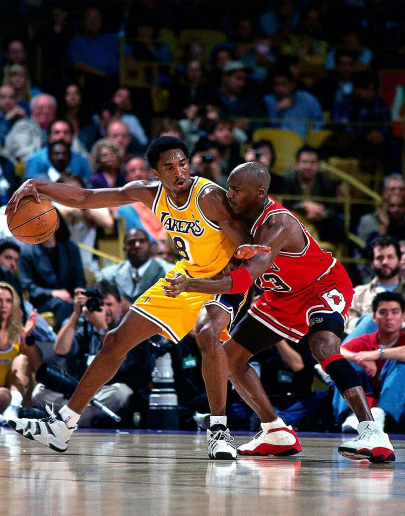 Iconic Collision: Michael Jordan and Kobe Bryant, Duel of Basketball Legends Wallpaper