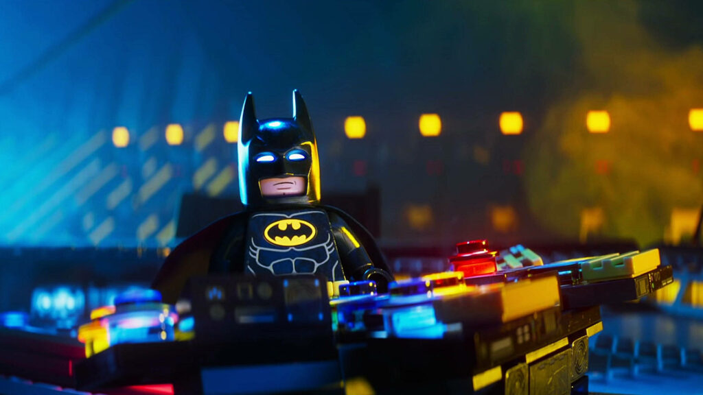 Lego Batman heroically at high-tech Batcave control panel with glowing lights wallpaper background