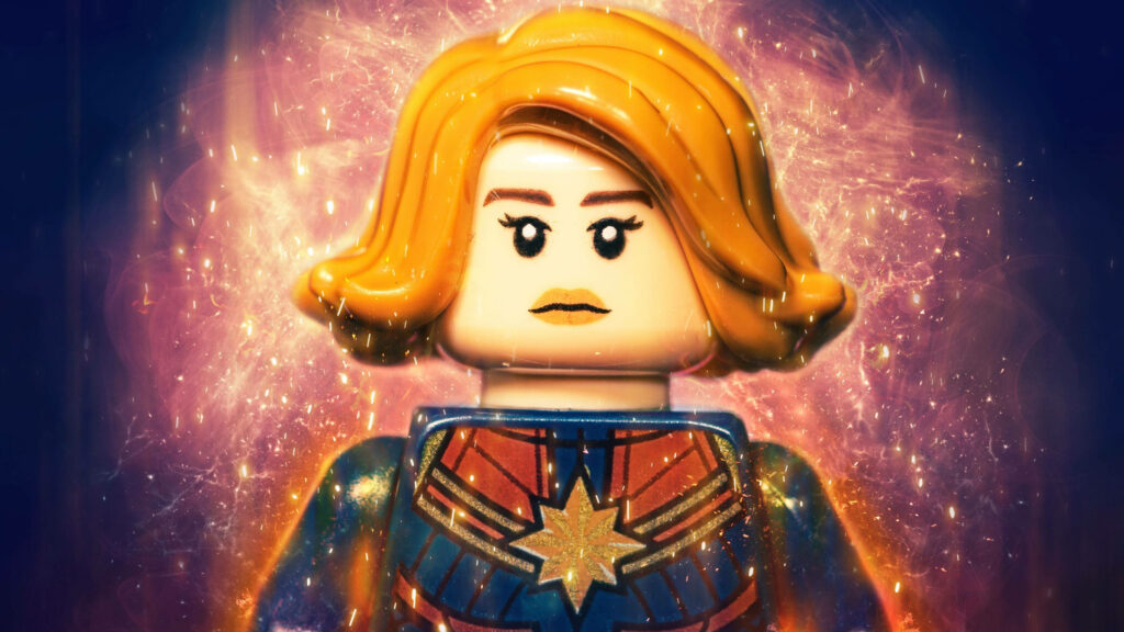 Lego Captain Marvel in iconic suit with dynamic energy effects on vibrant cosmic 4K wallpaper