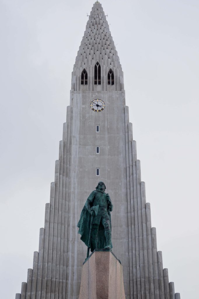 Leif Erikson statue and Hallgrímskirkja church Reykjavik dramatic low-angle photographic wallpaper