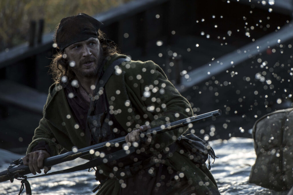 Leonardo DiCaprio in The Revenant intense survival scene with water splashing wild nature background Wallpaper