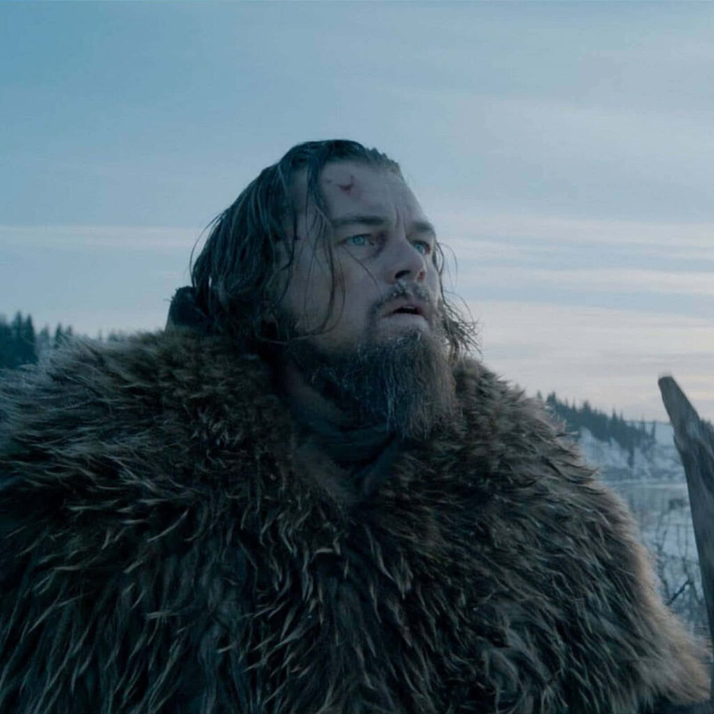 Leonardo DiCaprio in rugged fur coat against cold wintry landscape The Revenant wallpaper