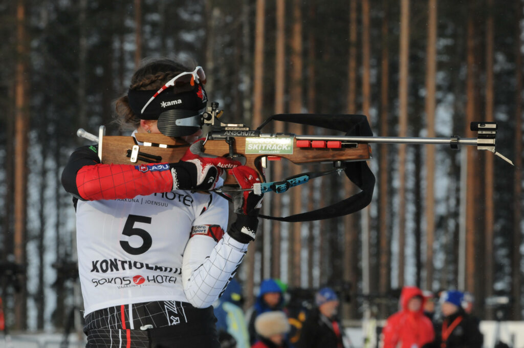 Leonie Litzenbauer: Prone Biathlete in Snowy Forest Wallpaper