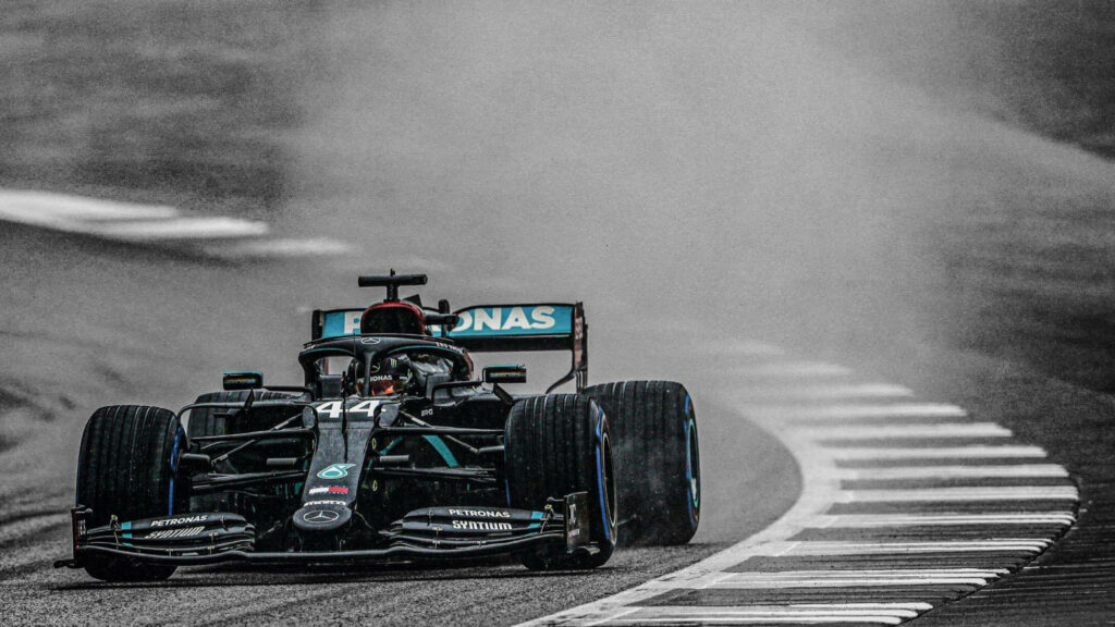 Lewis Hamilton F1 car racing fast on wet track dynamic wallpaper capturing intense power