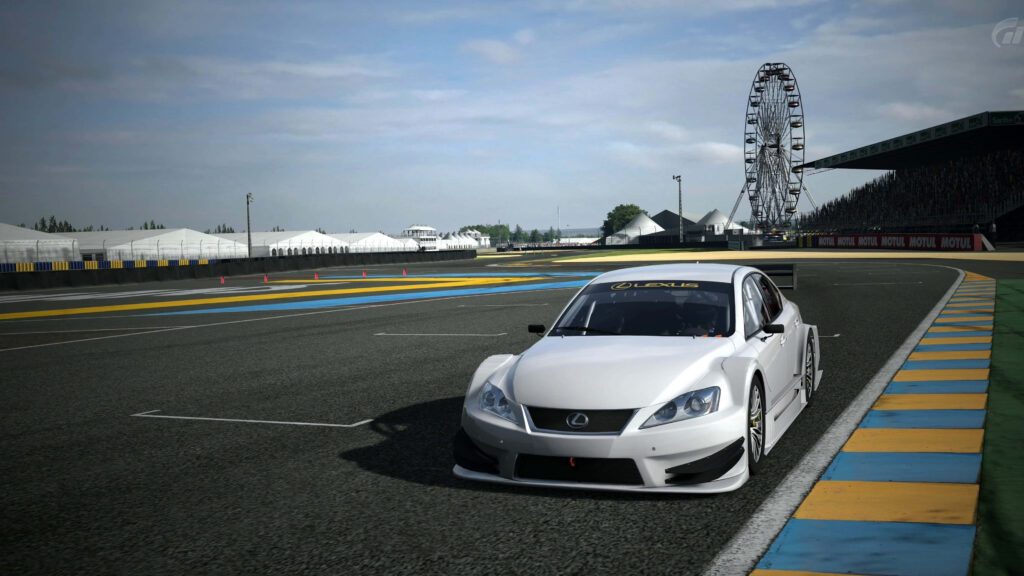 Sleek Lexus race car racing on professional track with ferris wheel under clear blue sky Wallpaper