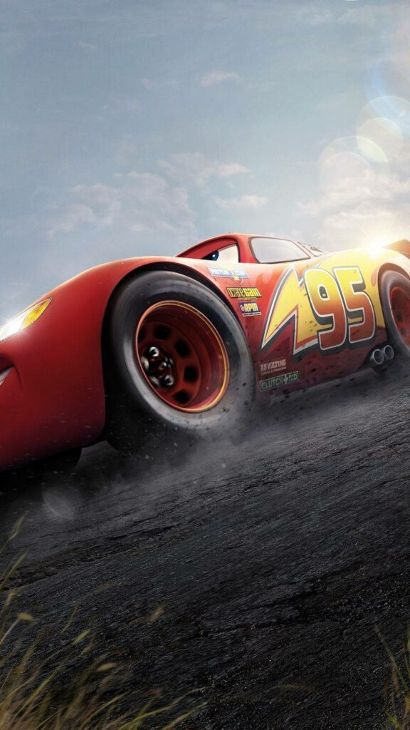 Lightning McQueen racing fast with motion blur and dust under bright sunlit sky wallpaper