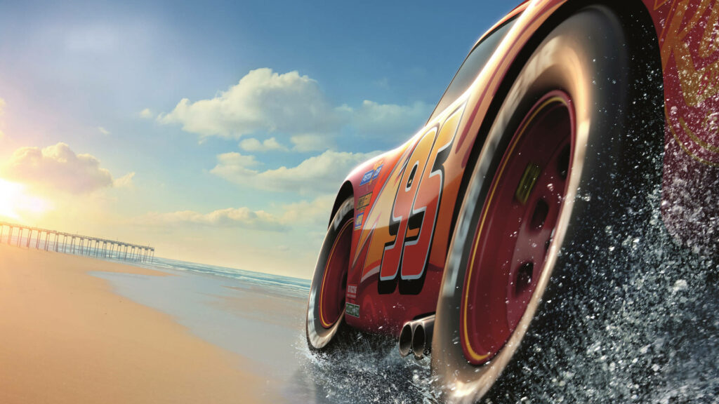 Lightning McQueen races on sunlit beach kicking up sand water vivid blue sky wallpaper background