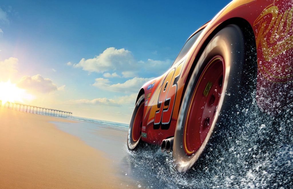 Lightning McQueen racing on sunny beach splashing through shallow coastal waters 8K wallpaper