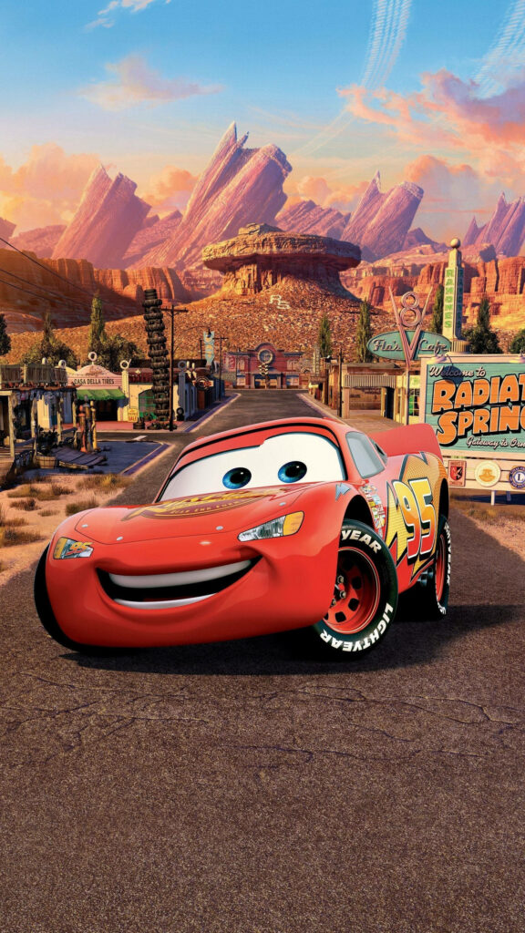 Lightning McQueen in Radiator Springs sunset with mountains vibrant Cars movie wallpaper background