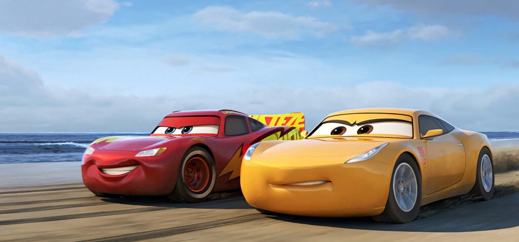 Lightning McQueen and Cruz Ramirez racing on sandy beach vibrant colors Cars 3 HD wallpaper