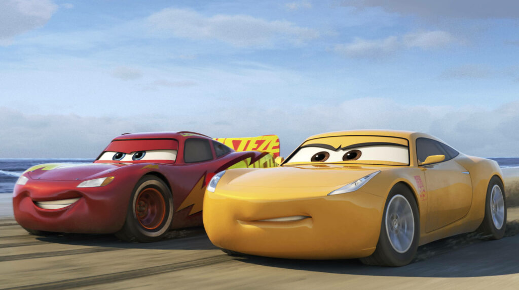 Lightning McQueen and Cruz Ramirez race on sandy beach vibrant Cars film animated wallpaper