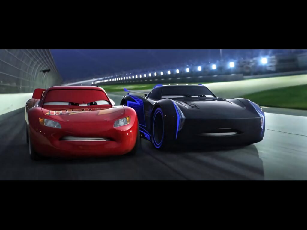 Lightning McQueen and Jackson Storm race side by side on a vibrant nighttime track in Cars 3 Wallpaper