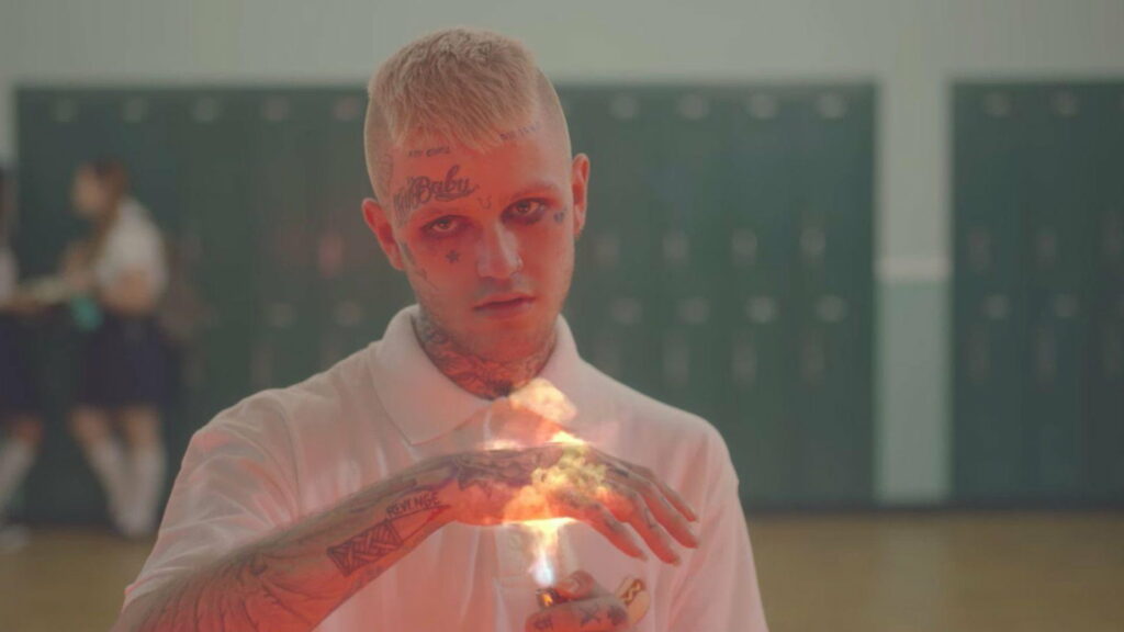 Fiery Resilience: Lil Peep Embracing His Unique Sound in a Blazing Ambience Wallpaper