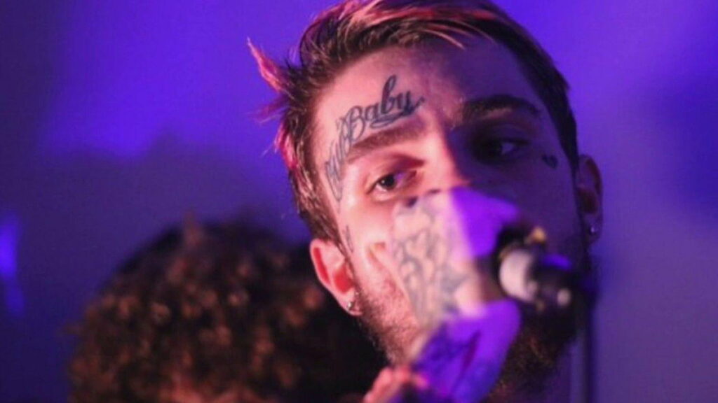 Vibrant HD Wallpaper: Lil Peep's Captivating Performance with Piercing Eyes, Tattooed Expression, and Melodic Voice