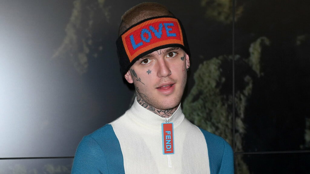 Lil Peep portrait wearing Fendi top LOVE headband with face tattoos dark moody background wallpaper