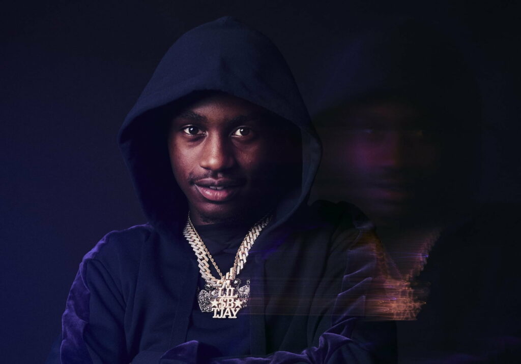 Melodic Master: Lil Tjay Takes Center Stage in Vibrant HD Music Wallpaper