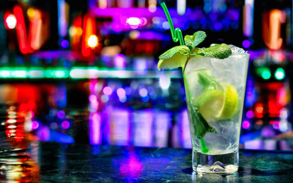 Neon Lime Libations: A Captivating Cocktail Composition on Vibrant Background Wallpaper
