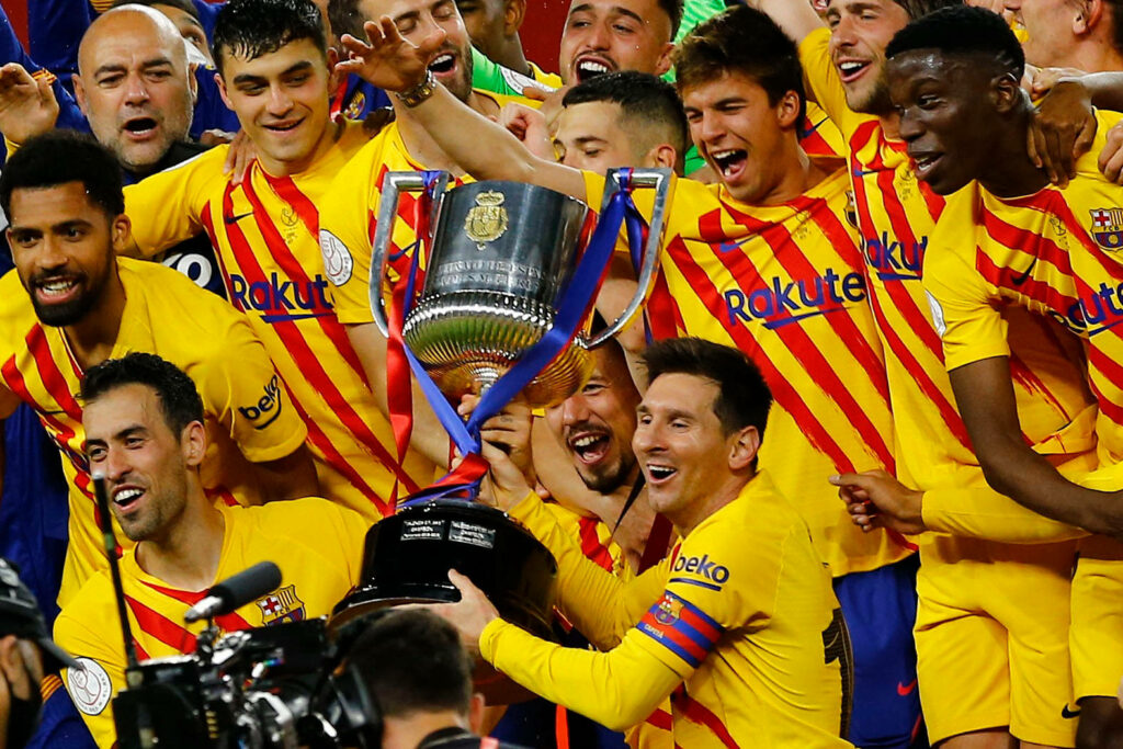 Lionel Messi and FC Barcelona celebrating Copa Del Rey 2021 victory in yellow and red kits Wallpaper