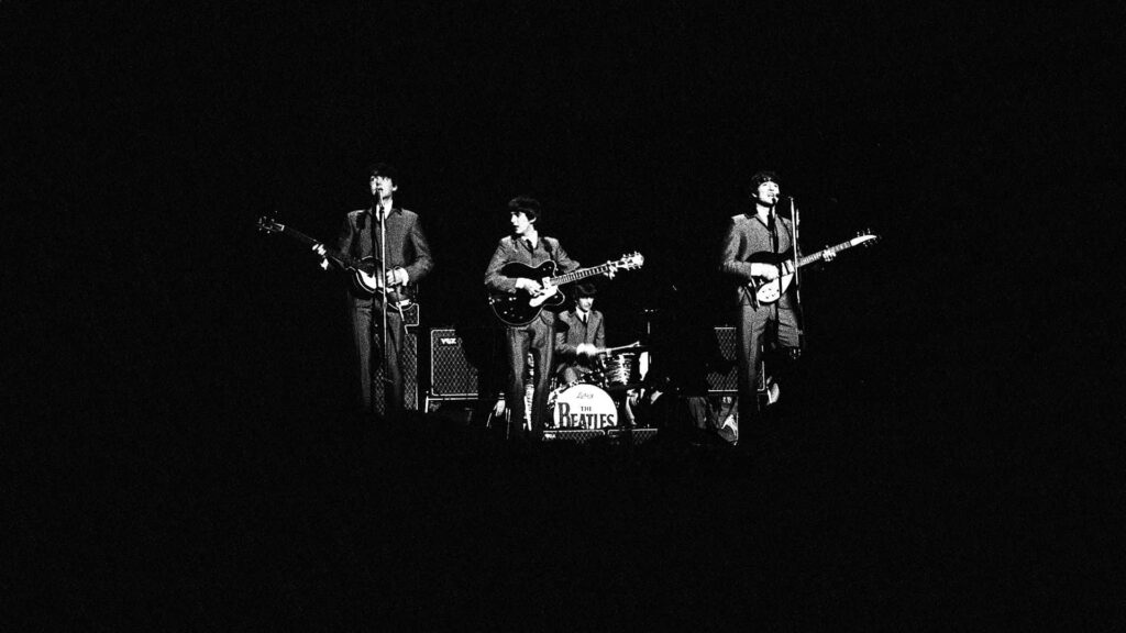 Iconic Beatles Live Performance Wallpaper Background
